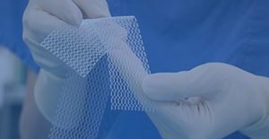 picture of surgeon holding a piece of hernia mesh